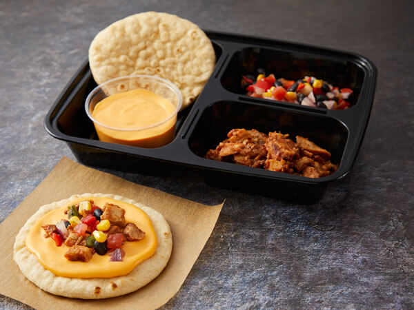Land O’Lakes Foodservice | BBQ Chicken Pizza Kit with BBQ chicken, mini flatbread rounds, Land O Lakes® Ultimate Cheddar™ Cheese Sauce and corn, pepper and onion blend